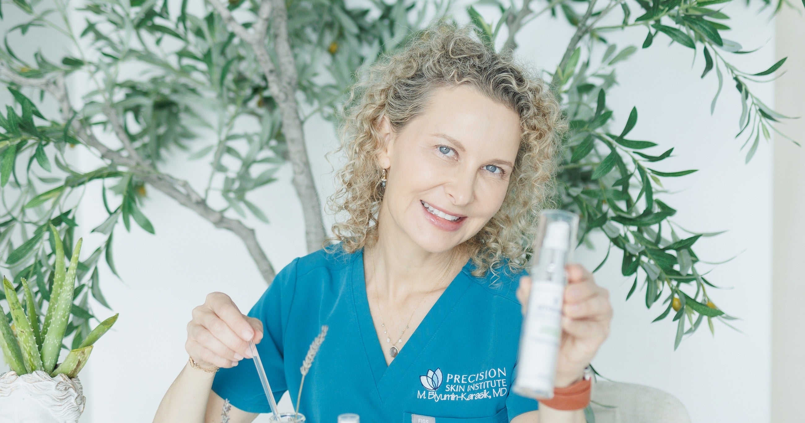 Dr. Marianna Blyumin-Karasik, founder of Stamina Cosmetics, holding a Stamina serum in her Precision Skin Institute lab